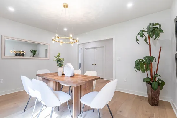 a view of a dining room with furniture and chandelier