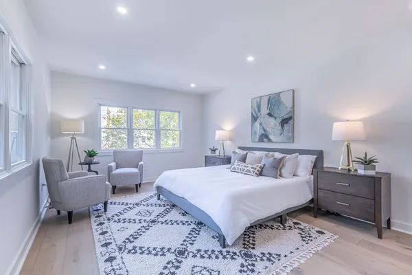 a bed room with bed and a large window