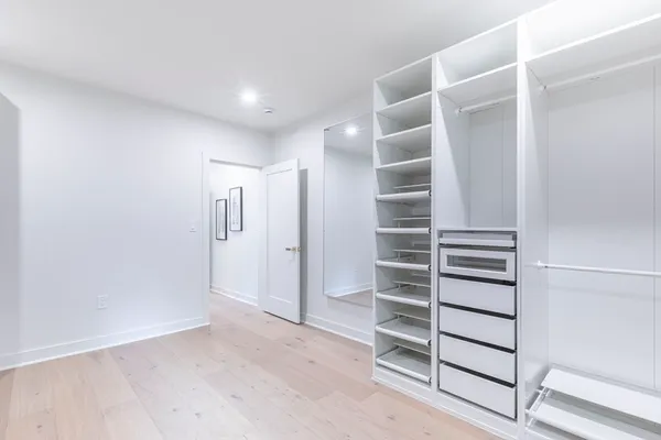 a view of walk in closet with empty racks