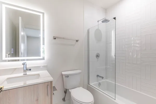 a bathroom with a sink toilet and shower