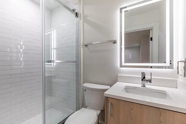 a bathroom with a sink toilet and shower