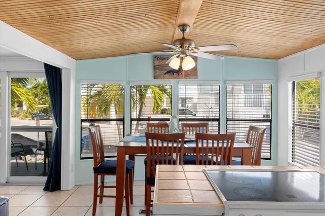 a kitchen with stainless steel appliances granite countertop a sink a stove and a wooden cabinets