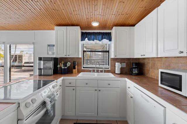 a kitchen with a refrigerator and a stove