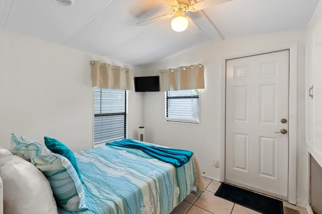 a view of an empty room with wooden floor and closet