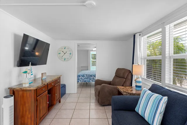 a living room with furniture and a floor to ceiling window