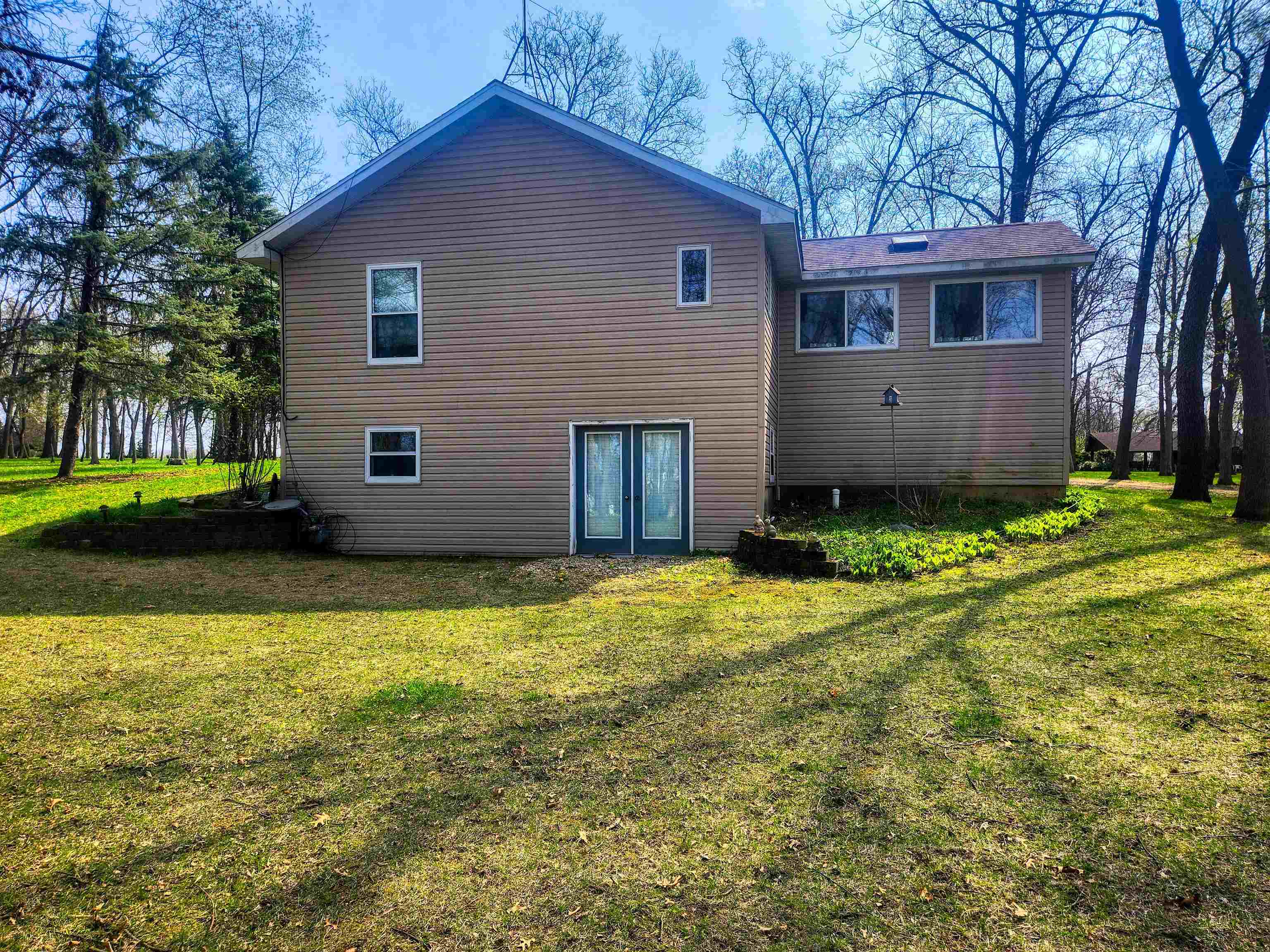 24344 Payne Road Shannon, IL 61078 - Photo 25 of 50 a front view of house with yard and trees in the background