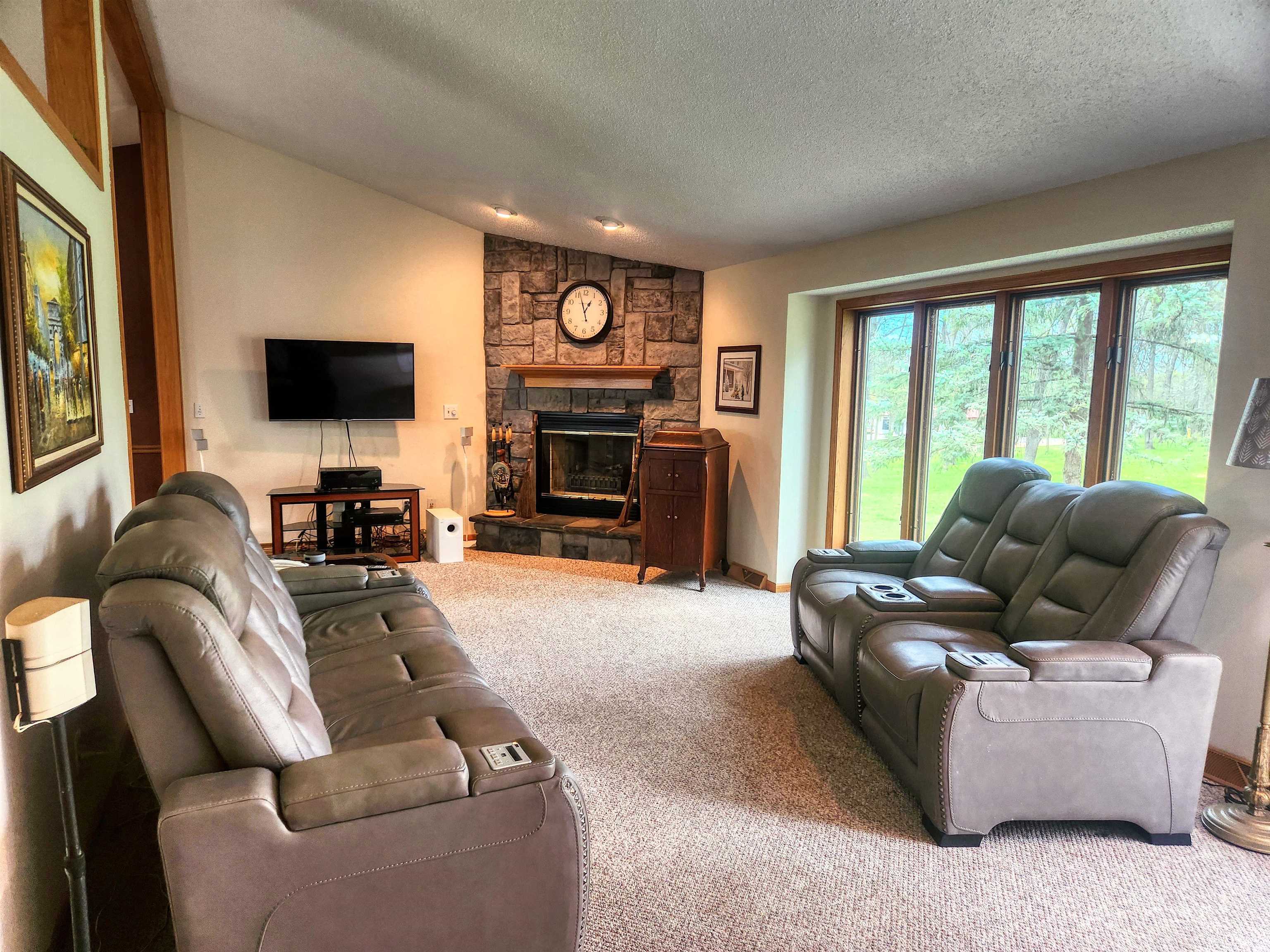 24344 Payne Road Shannon, IL 61078 - Photo 3 of 50 a living room with furniture a fireplace and a flat screen tv
