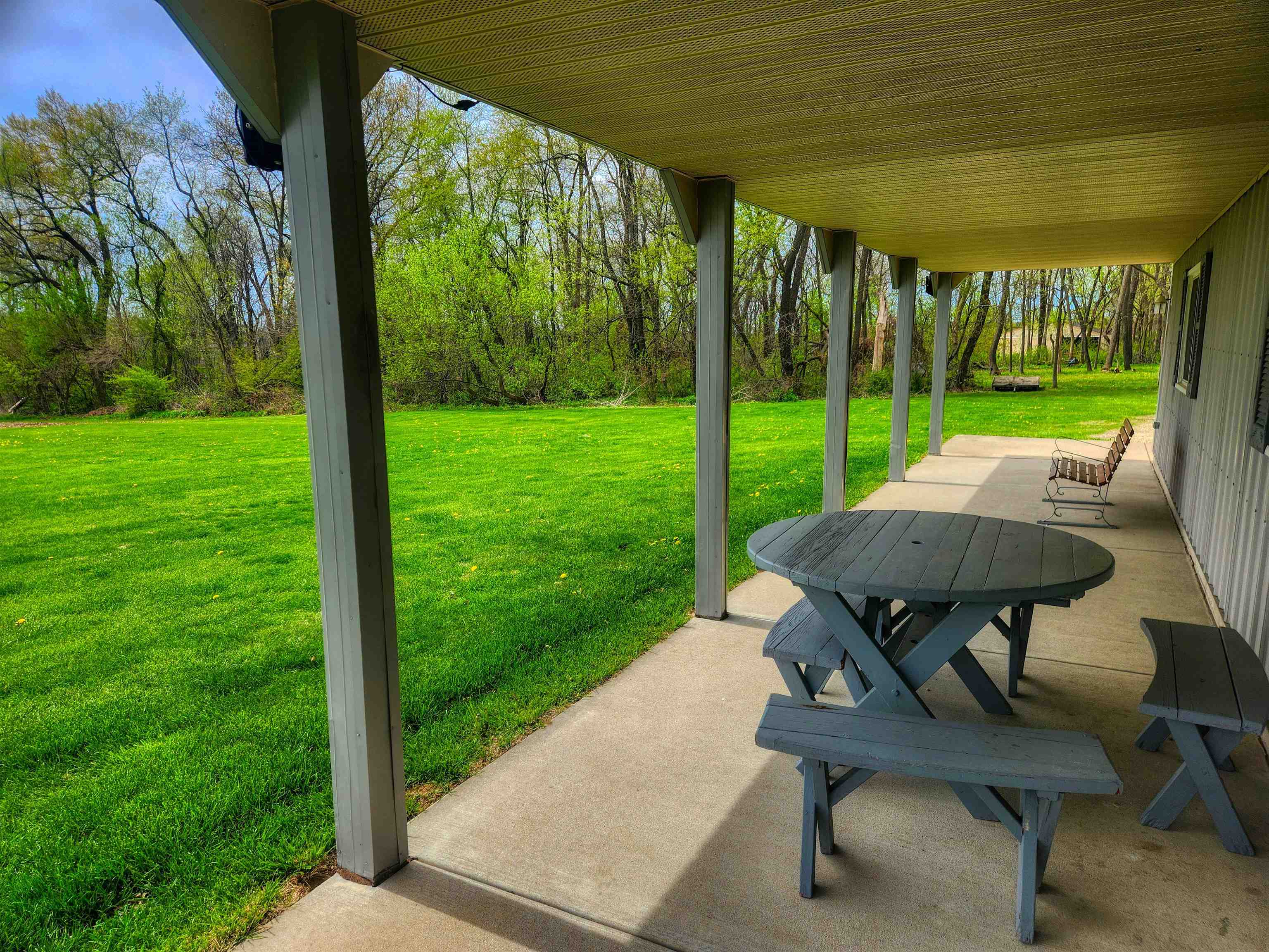 24344 Payne Road Shannon, IL 61078 - Photo 33 of 50 a view of a backyard with table and chairs under an umbrella with a small yard