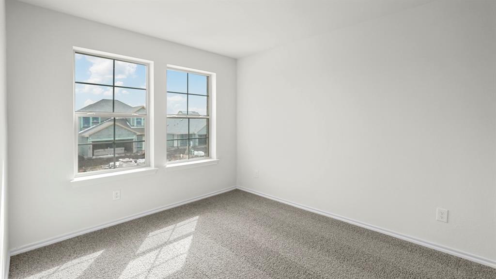 216 Pheasant Run Road Terrell, TX 75160 - Photo 15 of 37 Two large windows with grids, light gray carpet flooring, and white painted walls