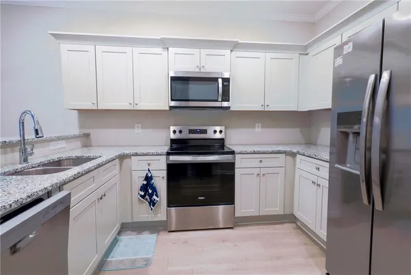 a kitchen with cabinets and steel stainless steel appliances