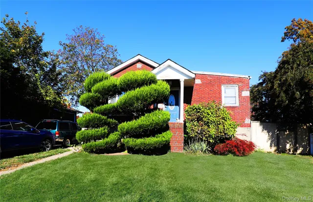 a front view of a house with garden