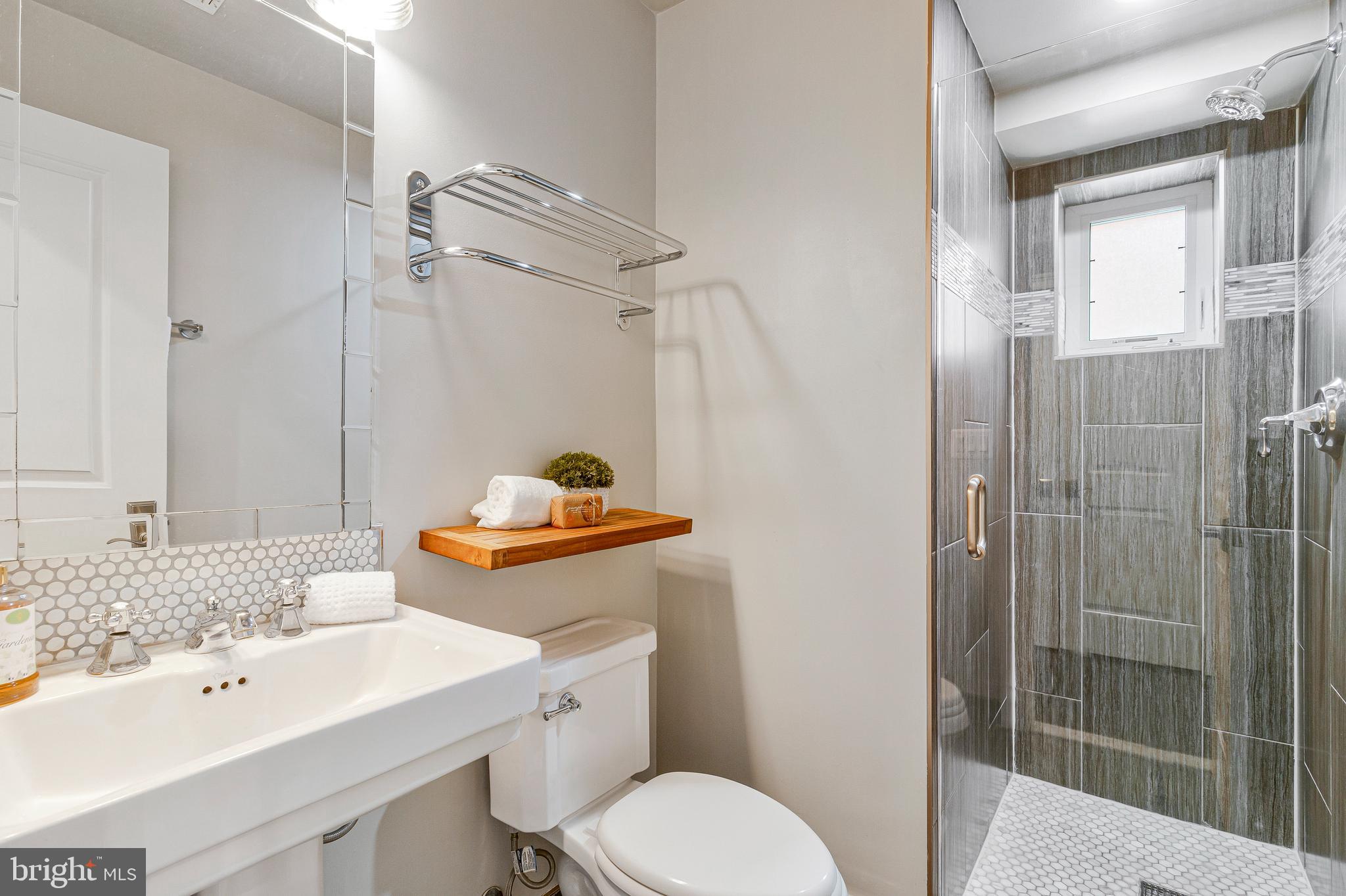 418 Seward Square Southeast, Unit 3 Washington, DC 20003 - Photo 11 of 16 a bathroom with a sink toilet and shower