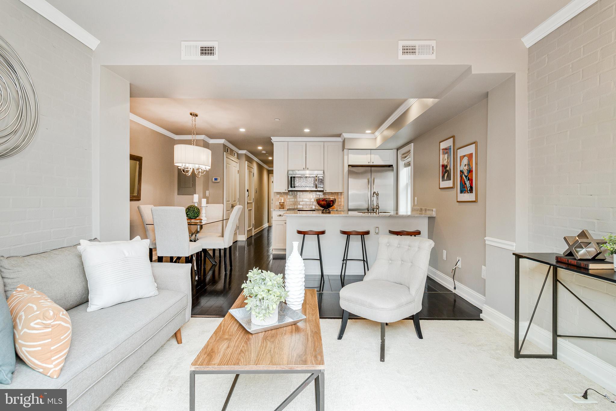 418 Seward Square Southeast, Unit 3 Washington, DC 20003 - Photo 2 of 16 a living room with furniture and a dining table with kitchen appliances