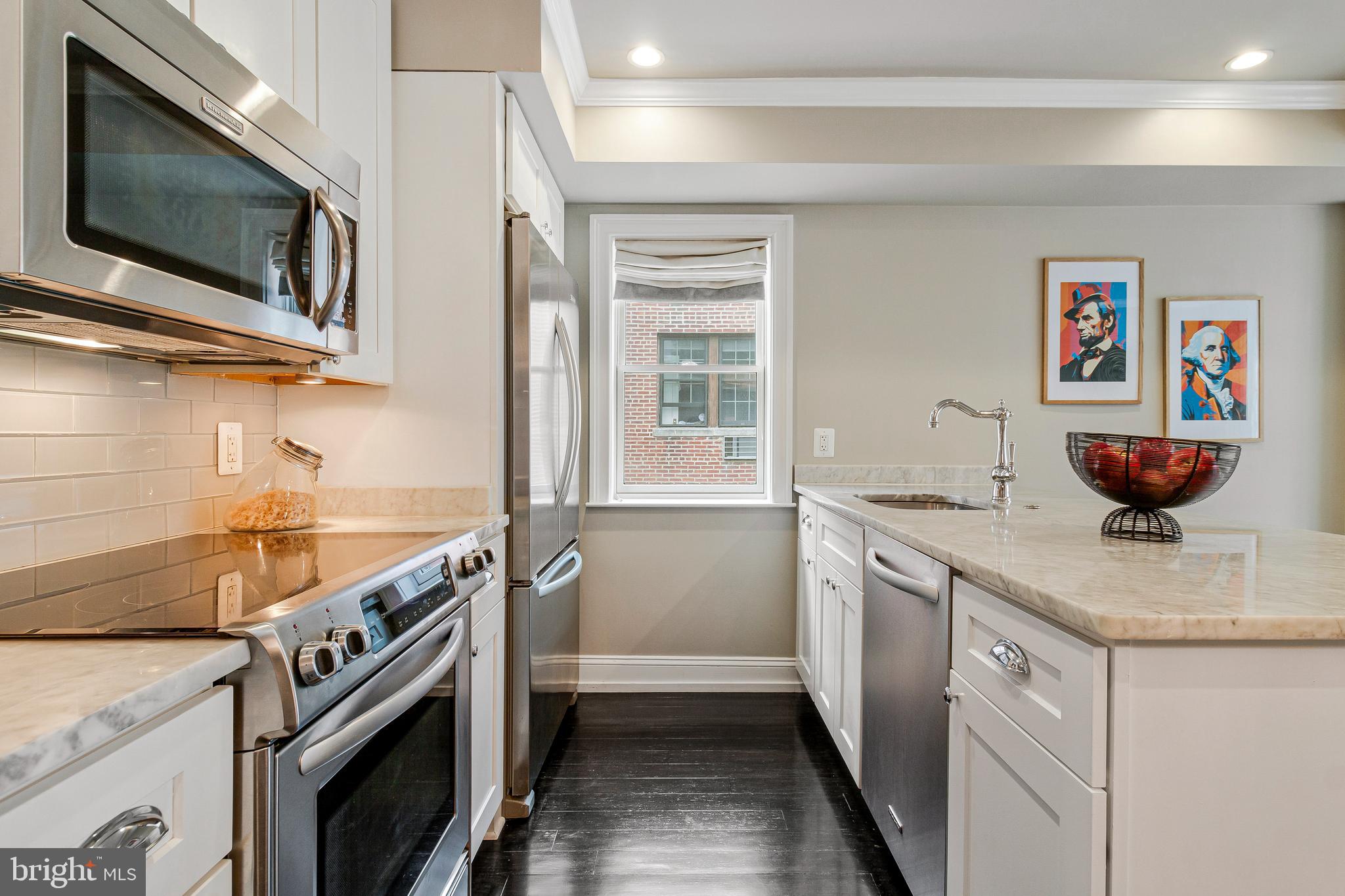 418 Seward Square Southeast, Unit 3 Washington, DC 20003 - Photo 7 of 16 a kitchen with stainless steel appliances granite countertop a sink and a stove