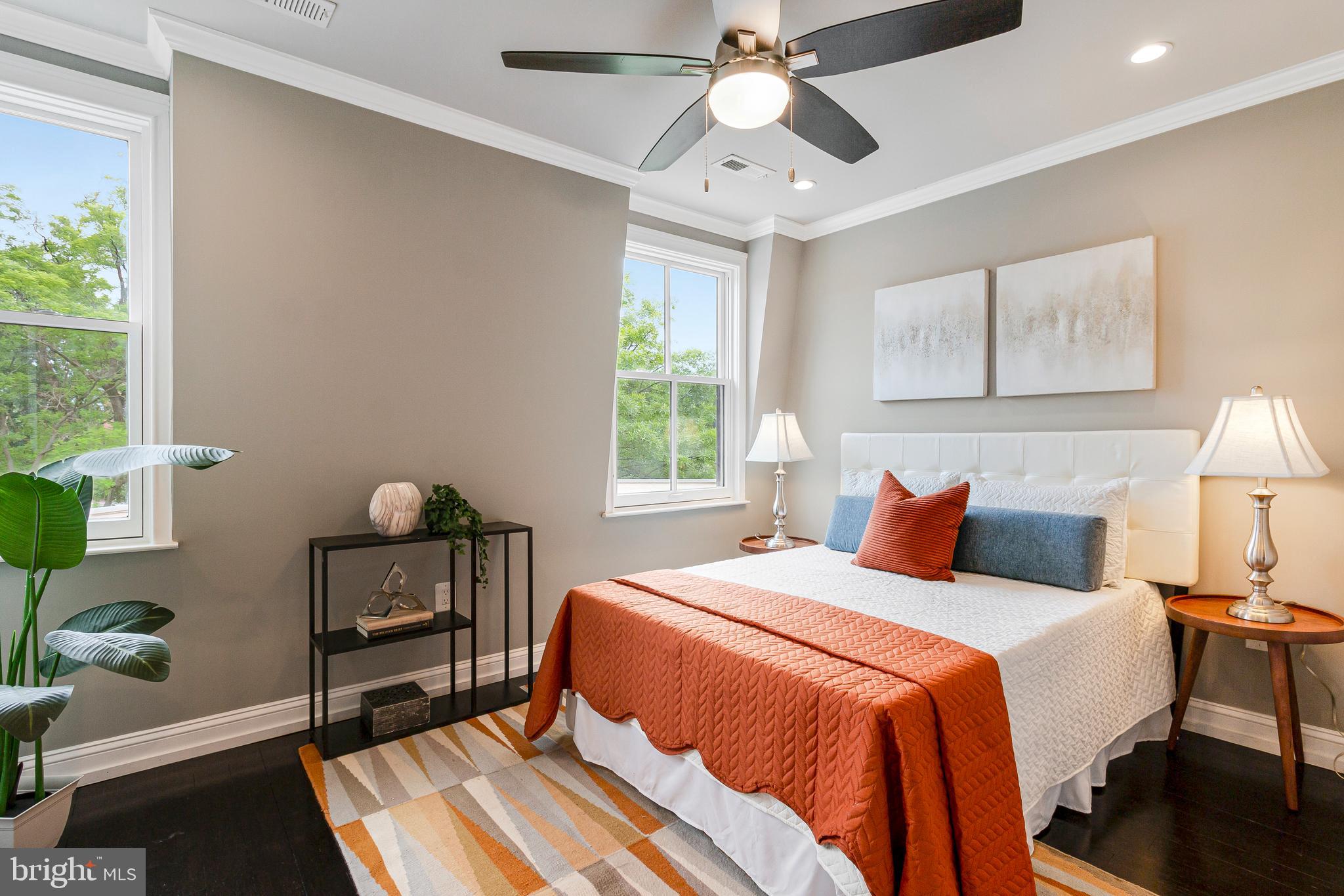 418 Seward Square Southeast, Unit 3 Washington, DC 20003 - Photo 8 of 16 a bedroom with a bed and a chandelier
