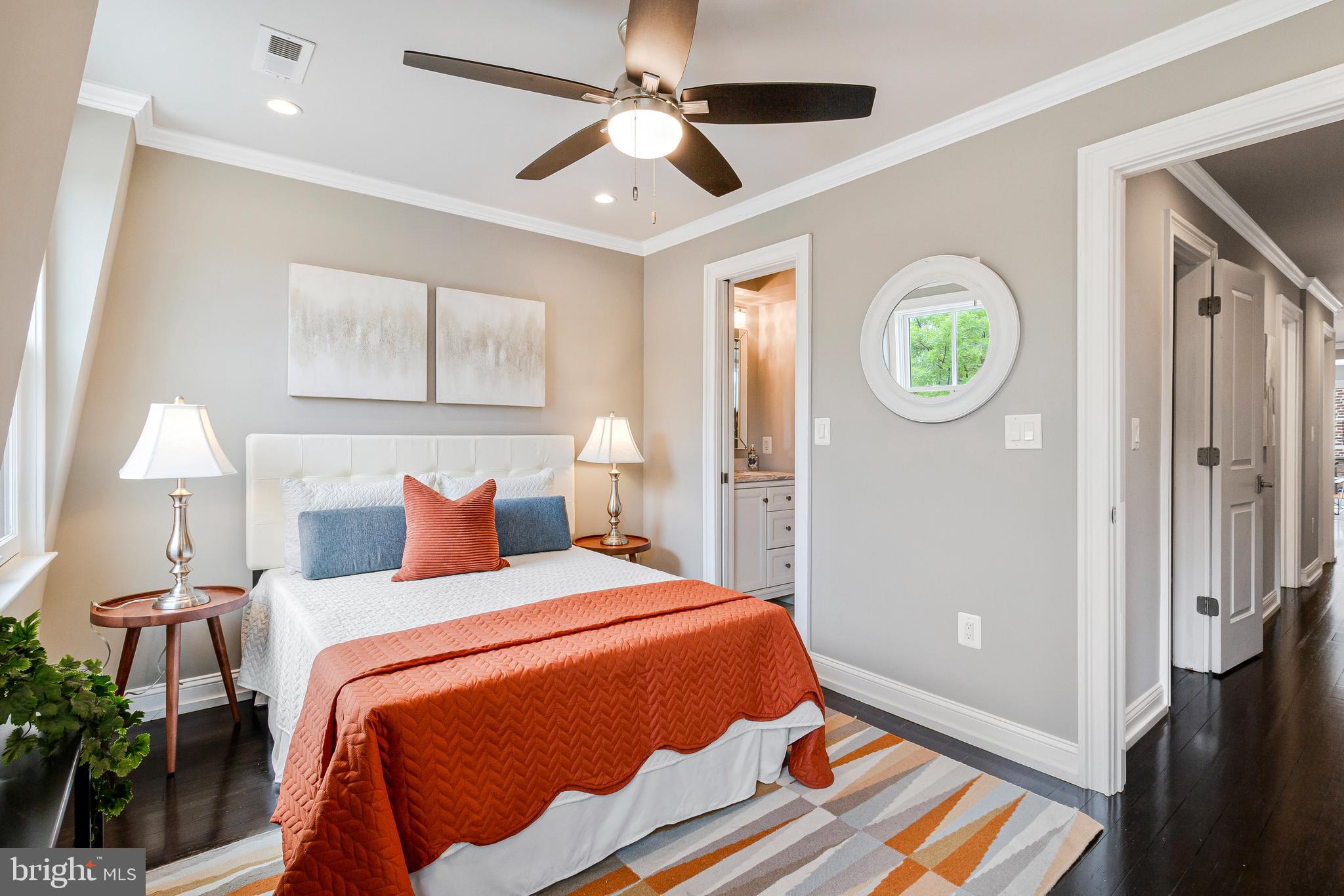 418 Seward Square Southeast, Unit 3 Washington, DC 20003 - Photo 9 of 16 a bedroom with a bed and a chandelier