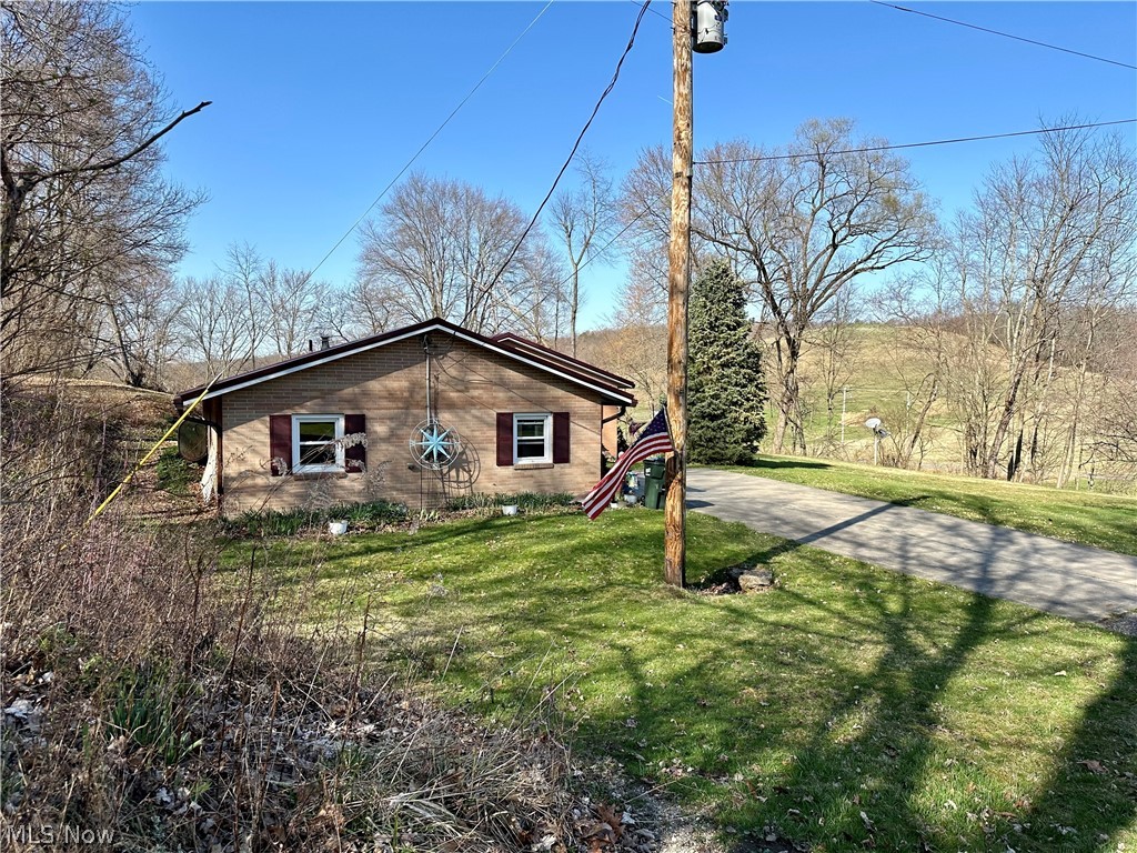111 Fort Road Southwest Dellroy, OH 44620 - Photo 3 of 38 View of property exterior with a yard