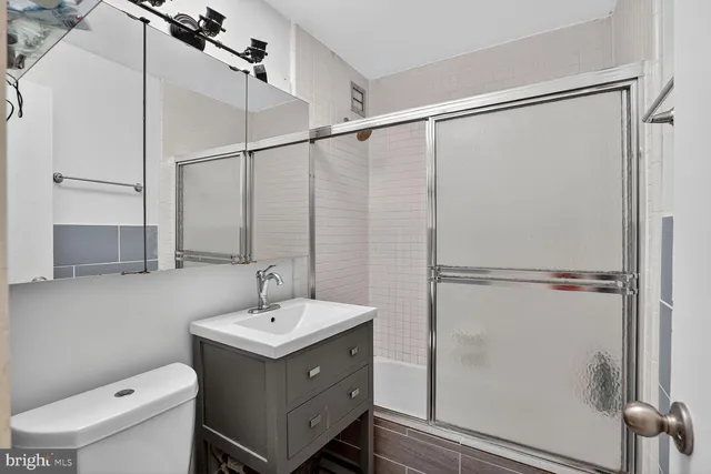 a bathroom with a sink toilet and shower