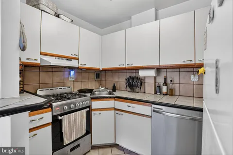 a kitchen with stainless steel appliances granite countertop a sink a stove and a microwave