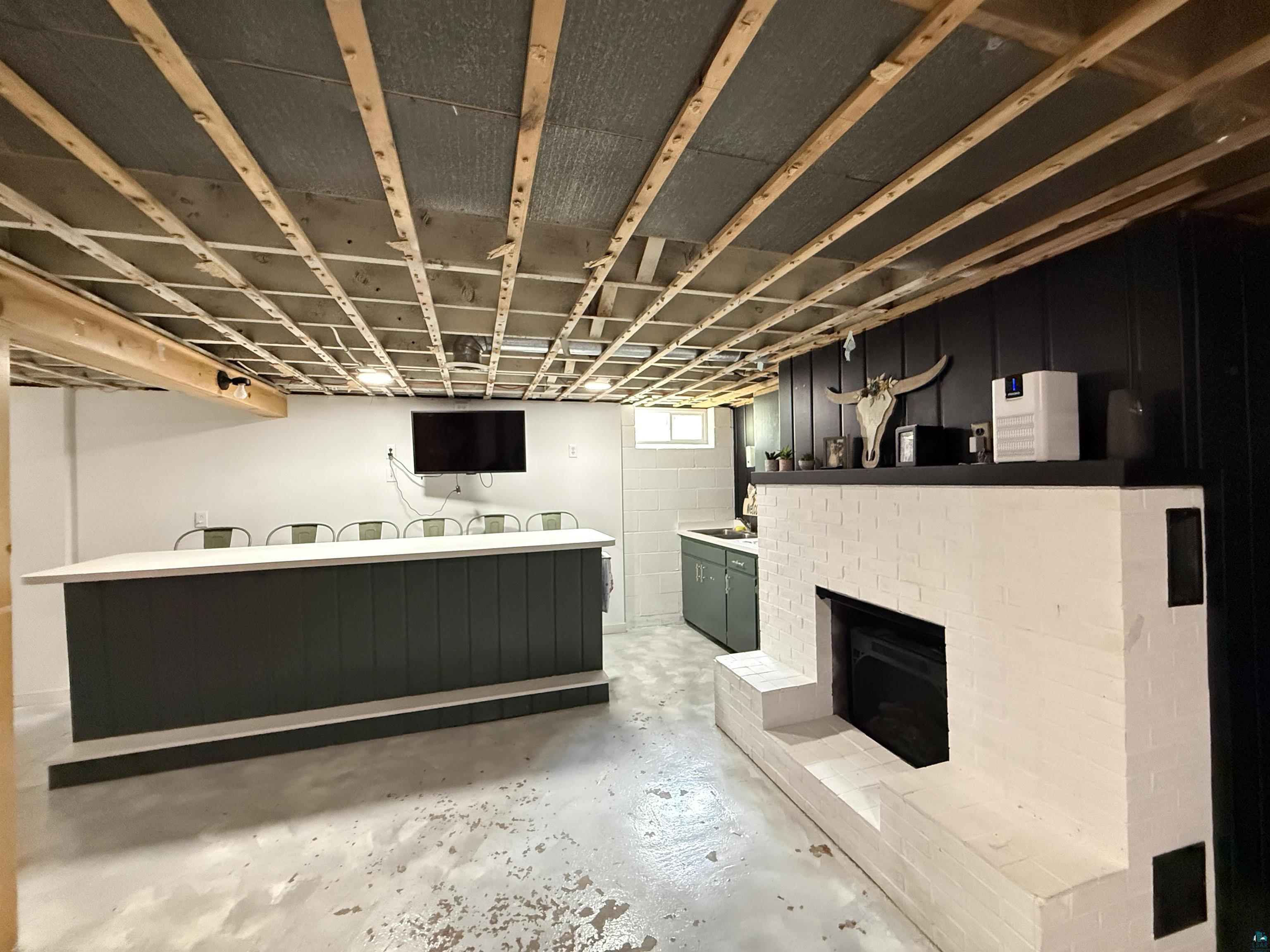 402 Alcohol Road Wrenshall, MN 55797 - Photo 18 of 24 White-painted brick fireplace with a black mantel