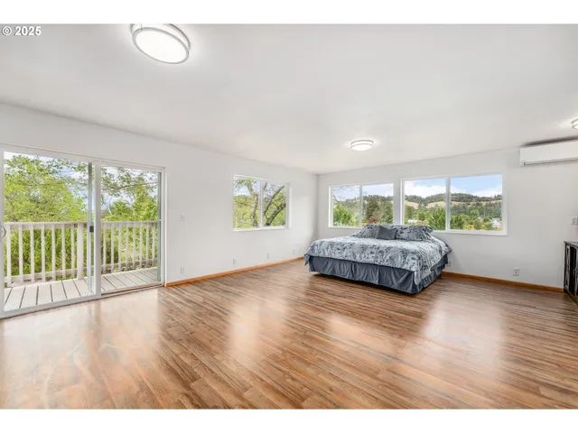 a living room with a bed furniture and a window