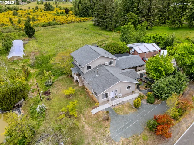 an aerial view of a house with a ocean view