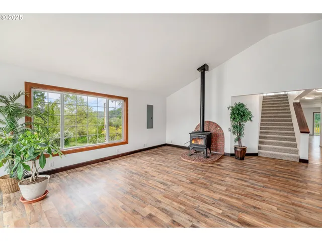 a view of a room with wooden floor and chair