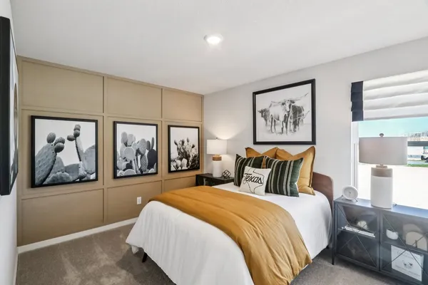 a bedroom with a large bed and a painting on the wall