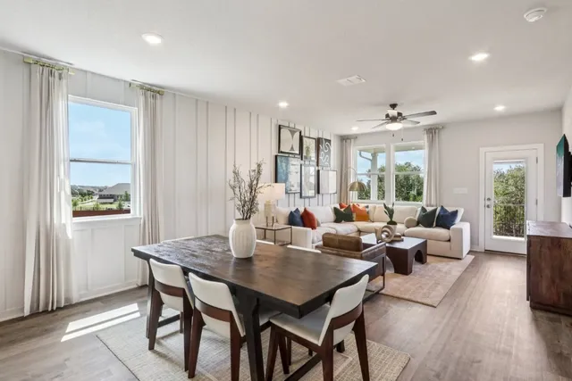 a living room with furniture potted plant and windows