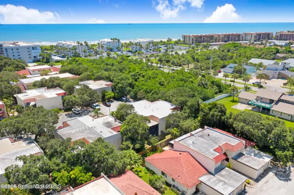 an aerial view of a houses with a yard