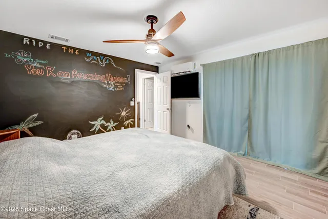 a bedroom with a bed and a chandelier