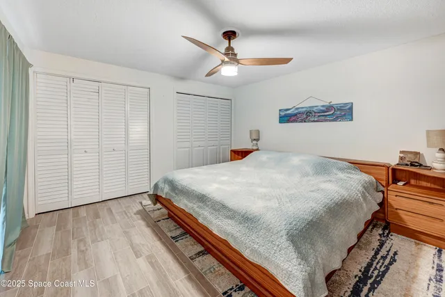 a bed sitting in a bedroom and chandelier
