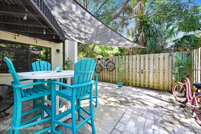 a view of outdoor dining space with a table and chairs