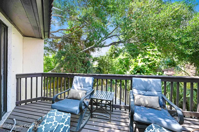 a view of a balcony with wooden floor