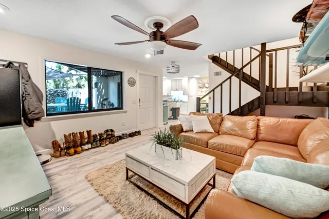 a living room with furniture ceiling fan and a rug