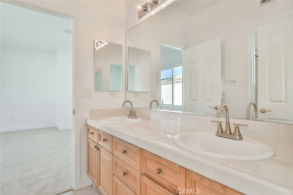 3966 Leighton Point Road Calabasas, CA 91301 - Photo 23 of 37 a bathroom with double sink and a mirror