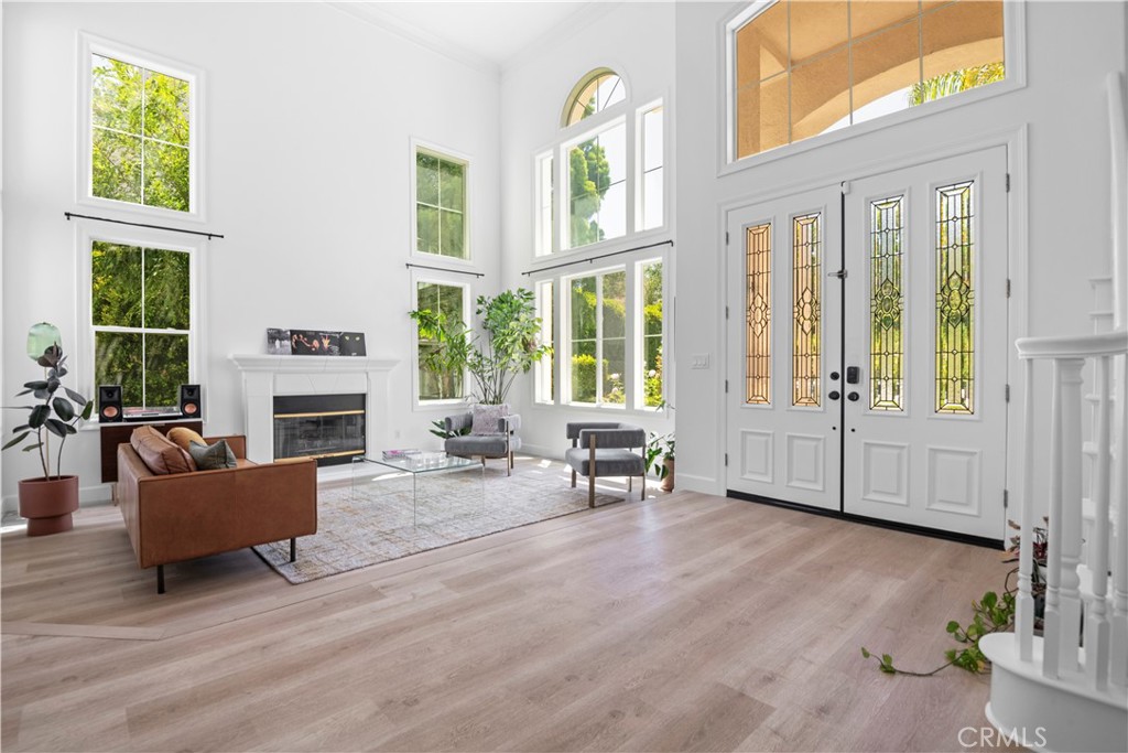 3966 Leighton Point Road Calabasas, CA 91301 - Photo 3 of 37 a living room with fireplace furniture and a large window