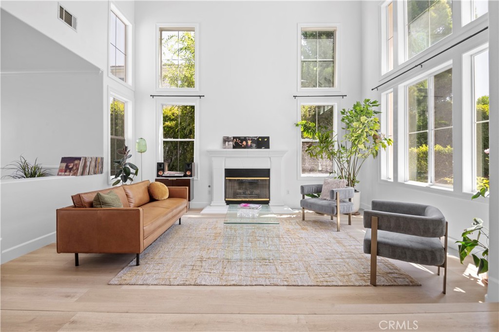 3966 Leighton Point Road Calabasas, CA 91301 - Photo 33 of 37 a living room with furniture windows and a fireplace