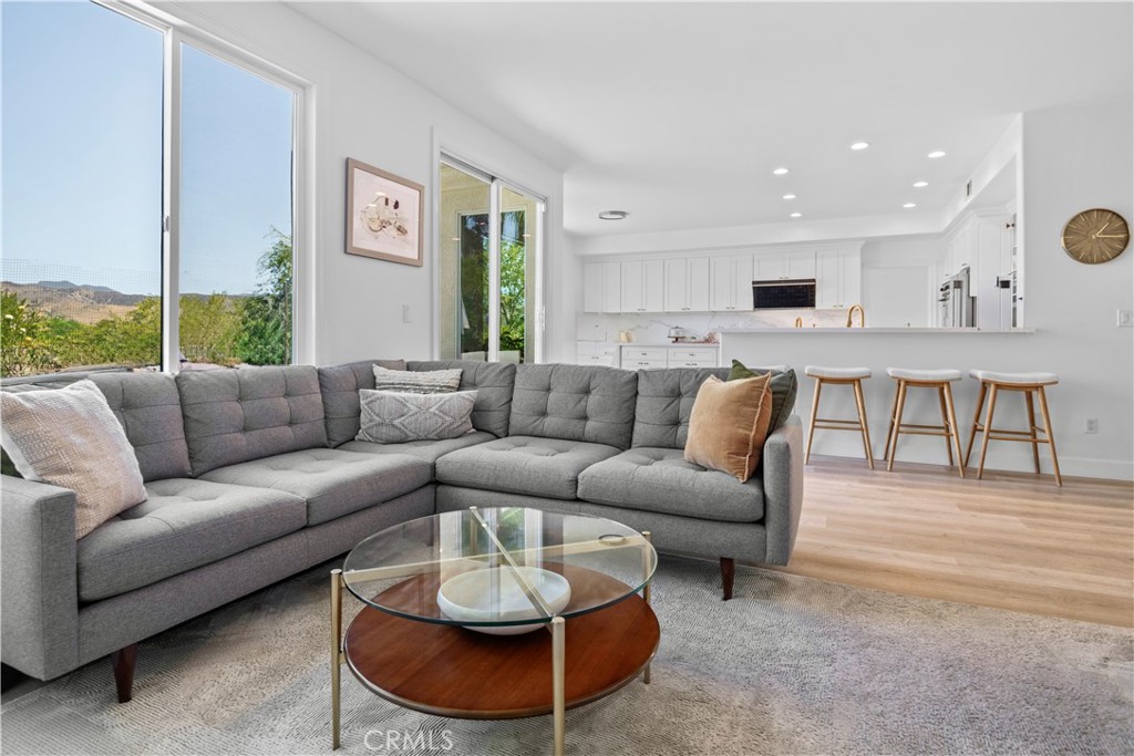 3966 Leighton Point Road Calabasas, CA 91301 - Photo 6 of 37 a living room with furniture a rug and kitchen view