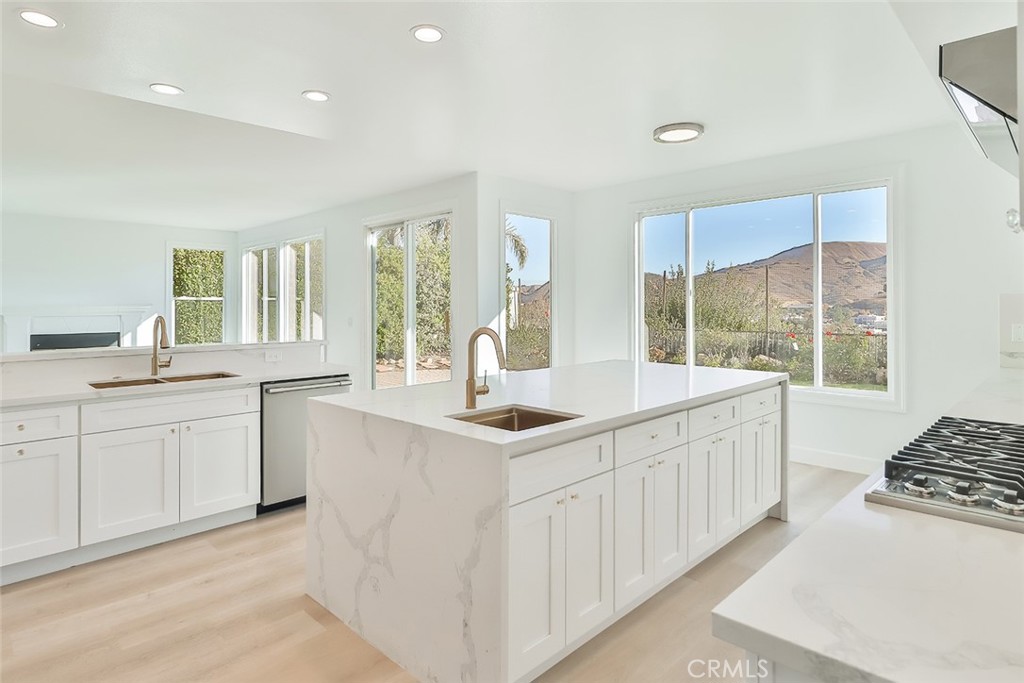 3966 Leighton Point Road Calabasas, CA 91301 - Photo 7 of 37 a kitchen with stainless steel appliances granite countertop a sink stove and cabinets