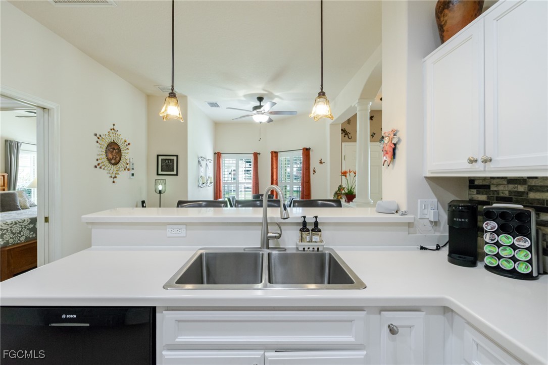 3610 Rue Alec Loop, Unit 1 North Fort Myers, FL 33917 - Photo 14 of 39 a kitchen with a sink a counter and cabinets