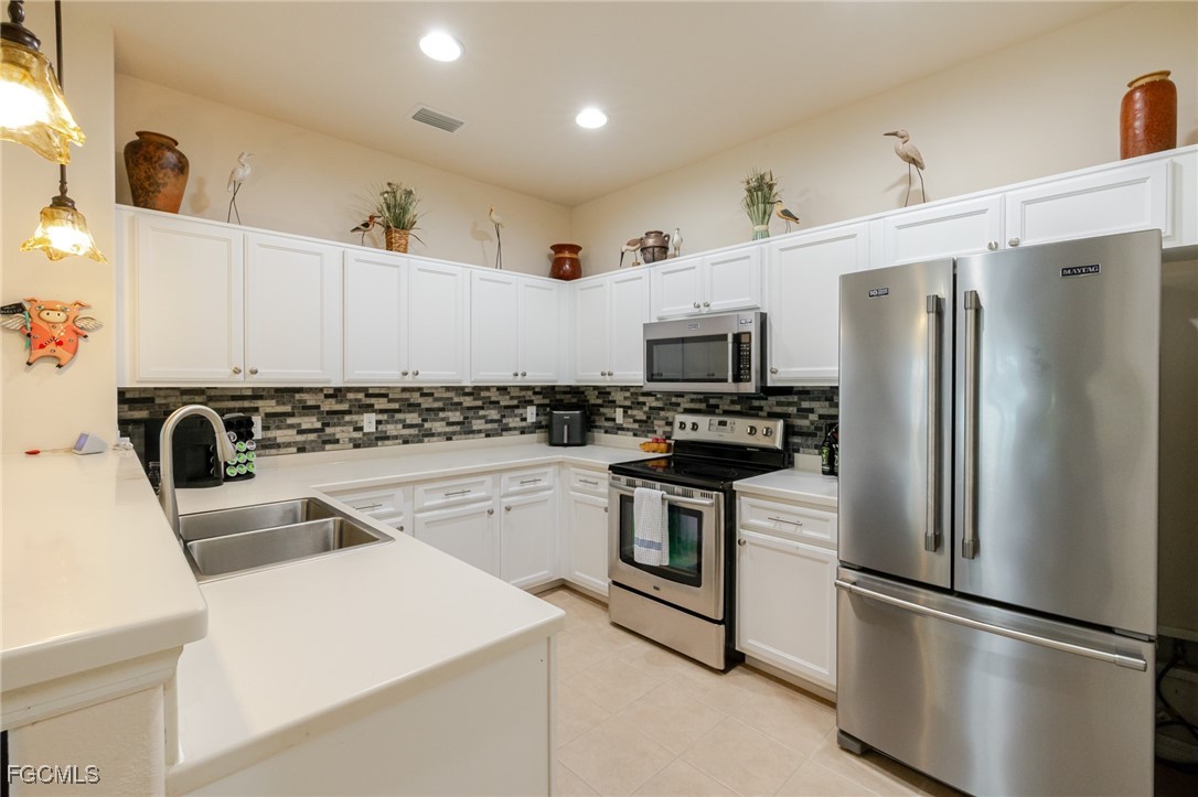 3610 Rue Alec Loop, Unit 1 North Fort Myers, FL 33917 - Photo 16 of 39 a kitchen with stainless steel appliances a refrigerator sink and microwave