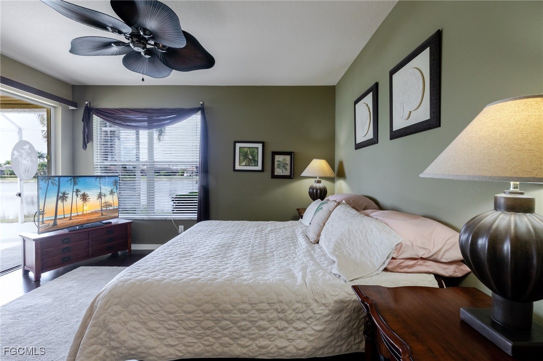 3610 Rue Alec Loop, Unit 1 North Fort Myers, FL 33917 - Photo 23 of 39 a bedroom with a bed and wooden floor