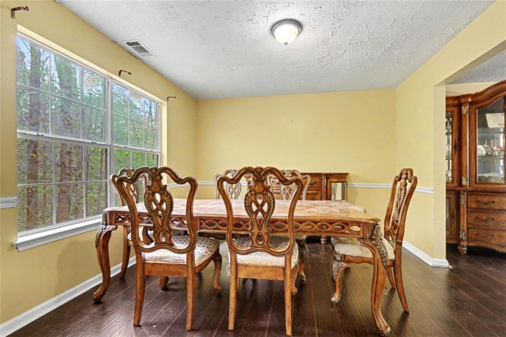 3111 Mineral Ridge Lane Stone Mountain, GA 30087 - Photo 4 of 5 a view of a dining room with furniture and wooden floor