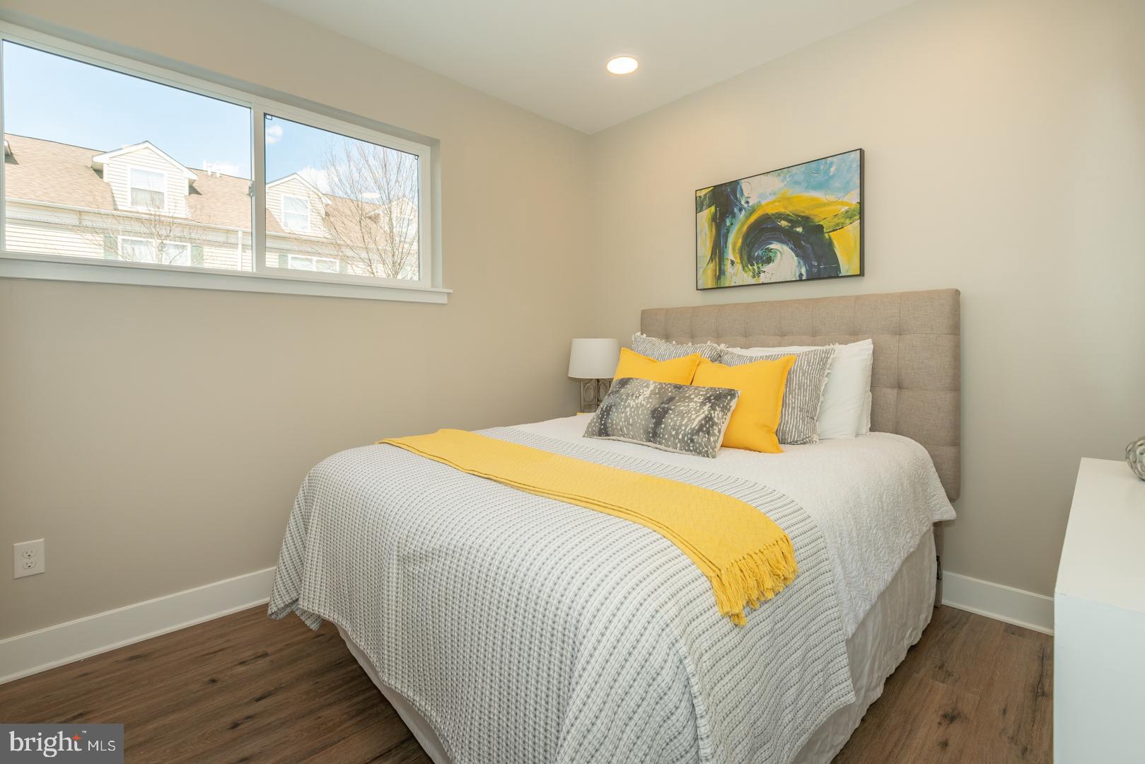 2220-28 Master Street, Unit 3 Philadelphia, PA 19121 - Photo 3 of 13 a bedroom with a bed and painting on the wall