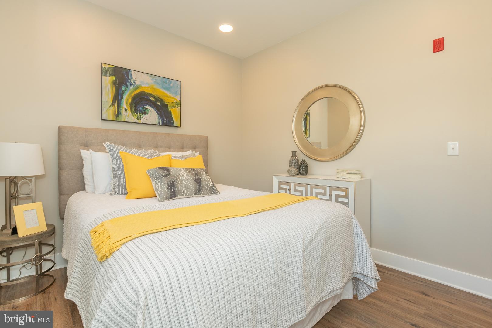 2220-28 Master Street, Unit 3 Philadelphia, PA 19121 - Photo 4 of 13 a bedroom with a bed and a painting on the wall