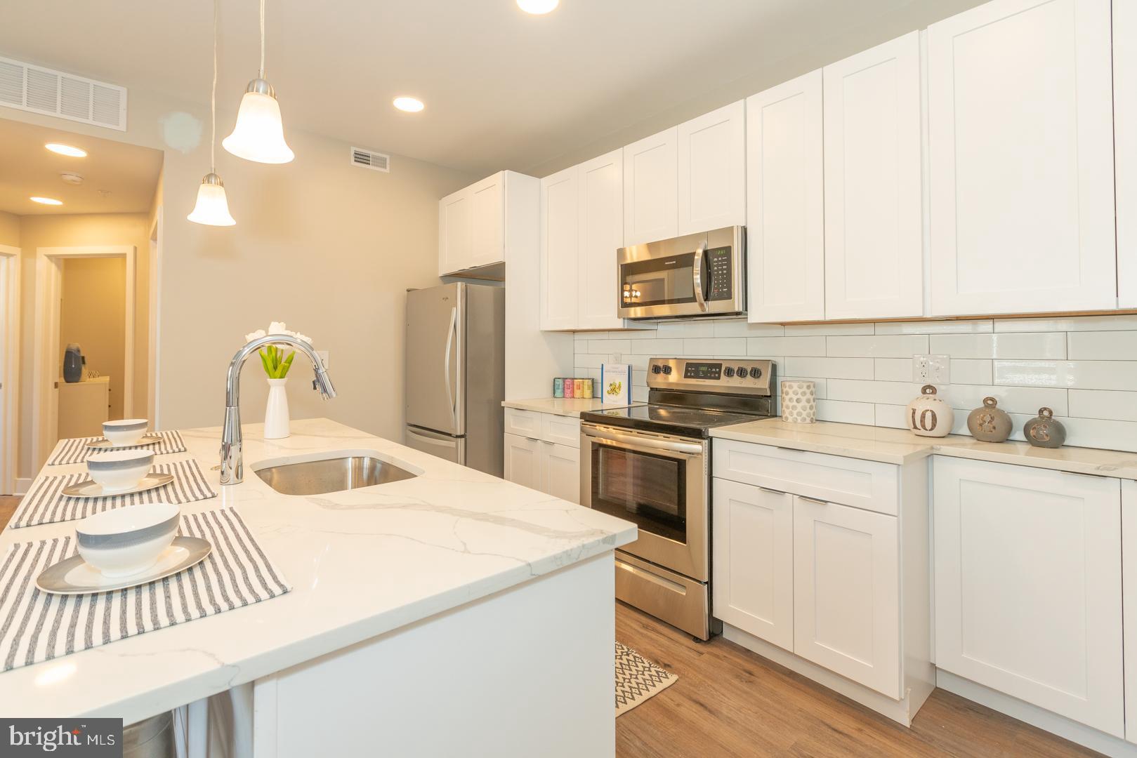 2220-28 Master Street, Unit 3 Philadelphia, PA 19121 - Photo 9 of 13 a kitchen with a sink stove and refrigerator
