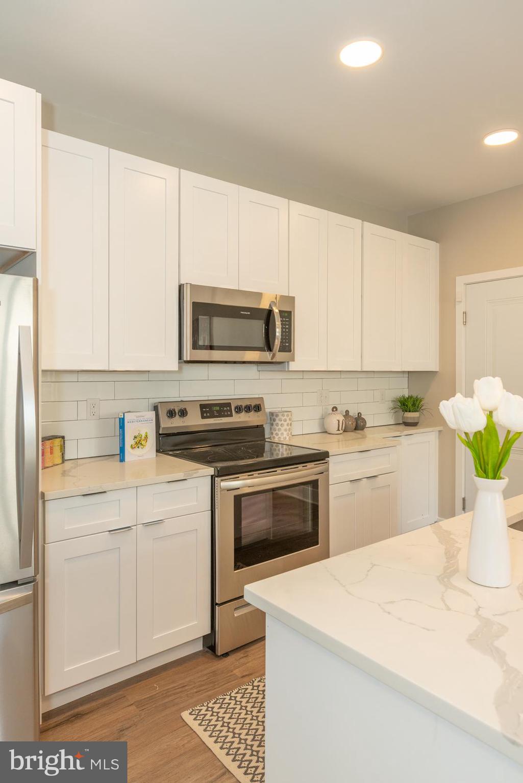 2220-28 Master Street, Unit 3 Philadelphia, PA 19121 - Photo 10 of 13 a kitchen with a white cabinets and white appliances