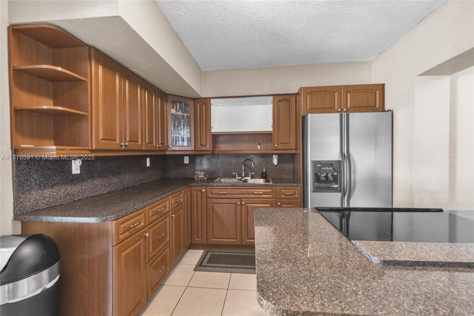 22270 Southwest 109th Avenue Miami, FL 33176 - Photo 15 of 48 a kitchen with stainless steel appliances granite countertop a refrigerator sink and cabinets
