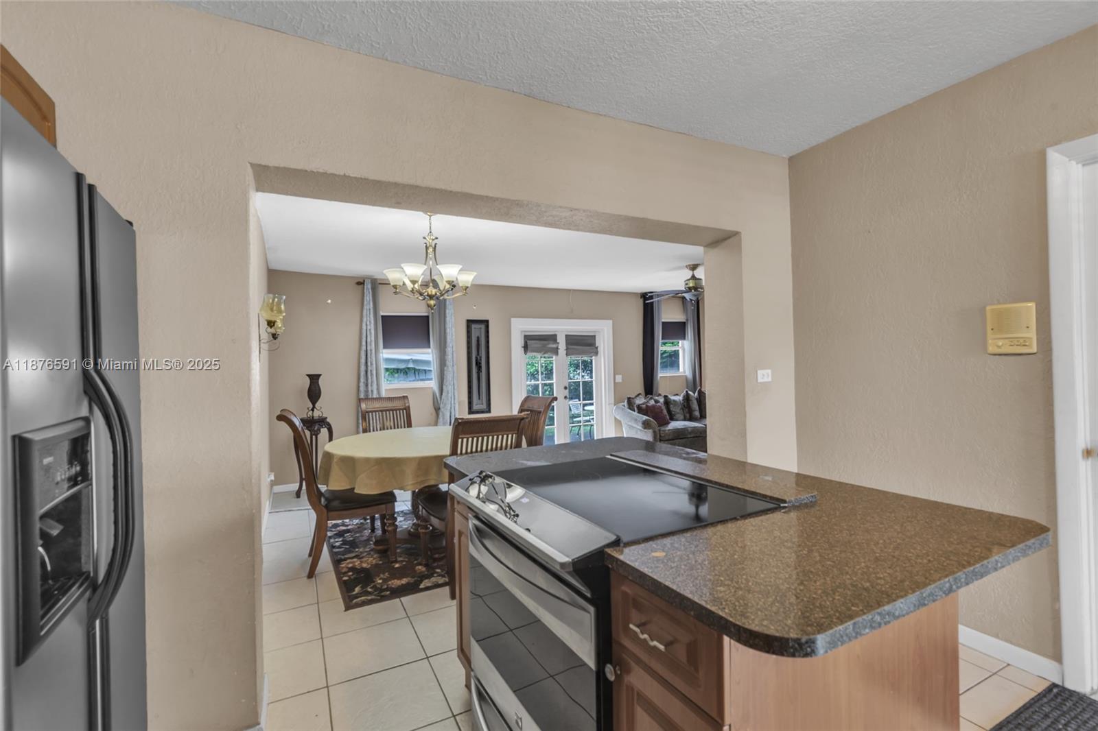 22270 Southwest 109th Avenue Miami, FL 33176 - Photo 16 of 48 a kitchen with stainless steel appliances granite countertop a sink and a refrigerator
